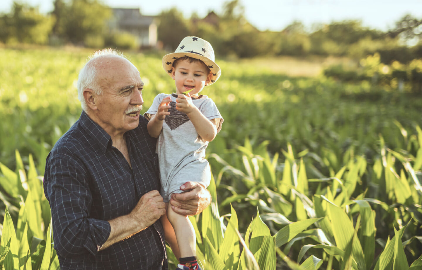 Farmer in field with grandchild