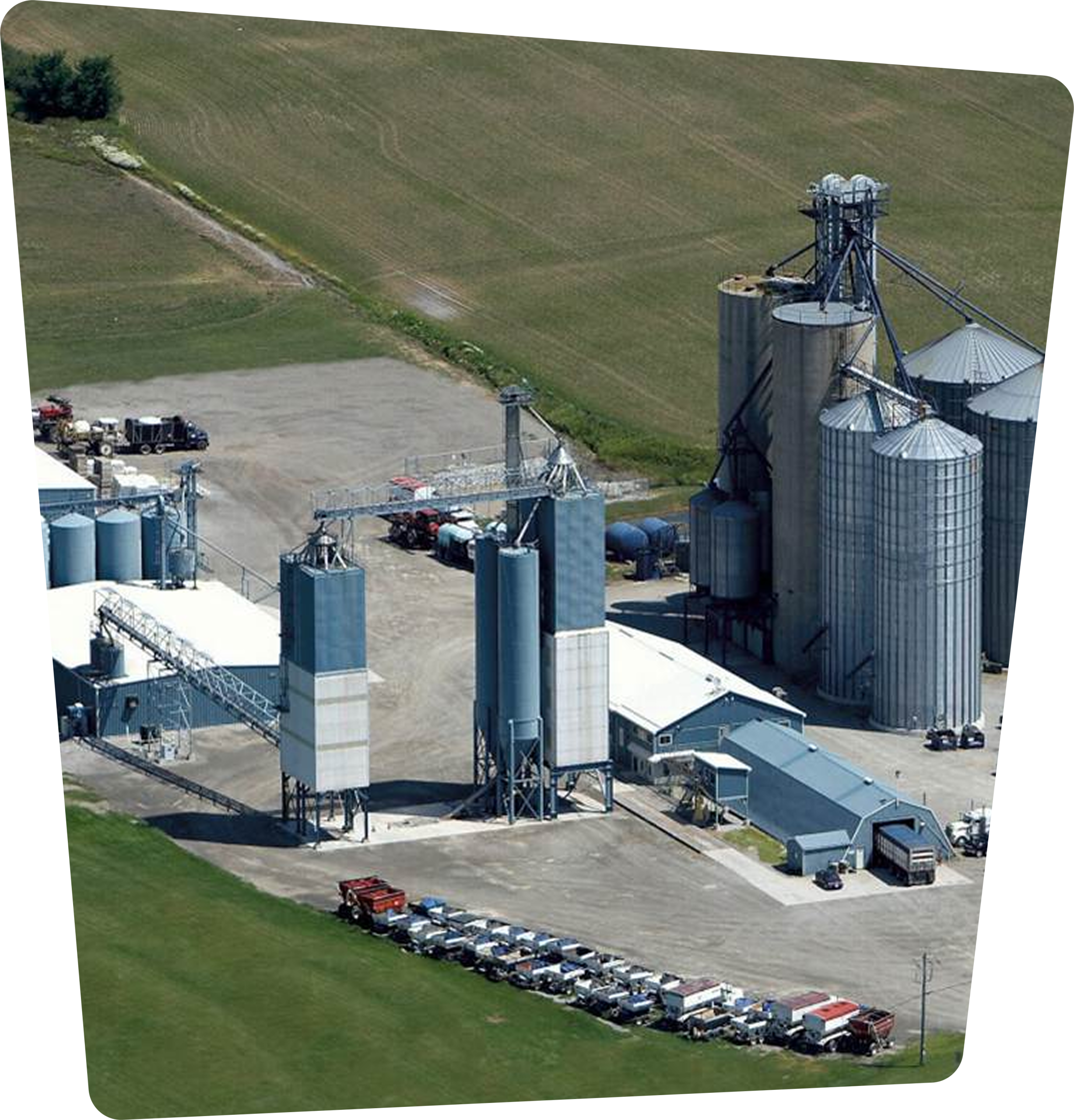 Aerial view of a grain facility with multiple silos and storage structures.