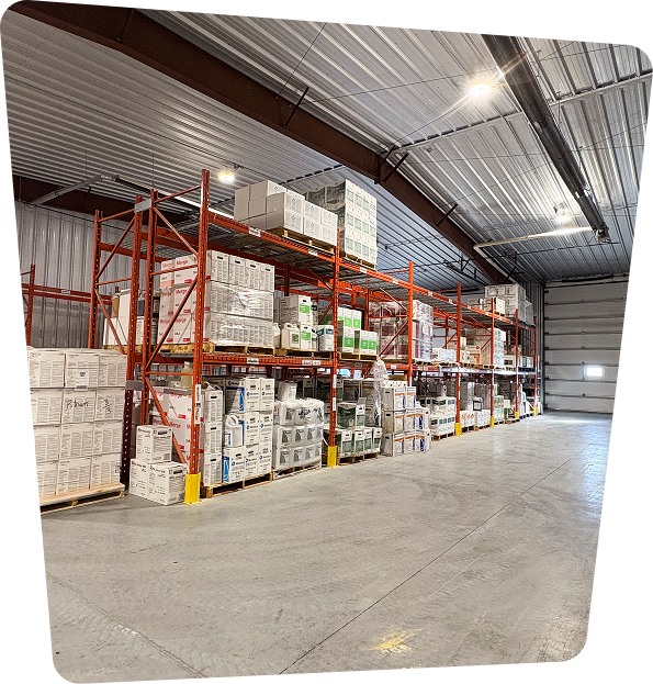 Warehouse interior with stacked shelves filled with agricultural supplies and boxes.