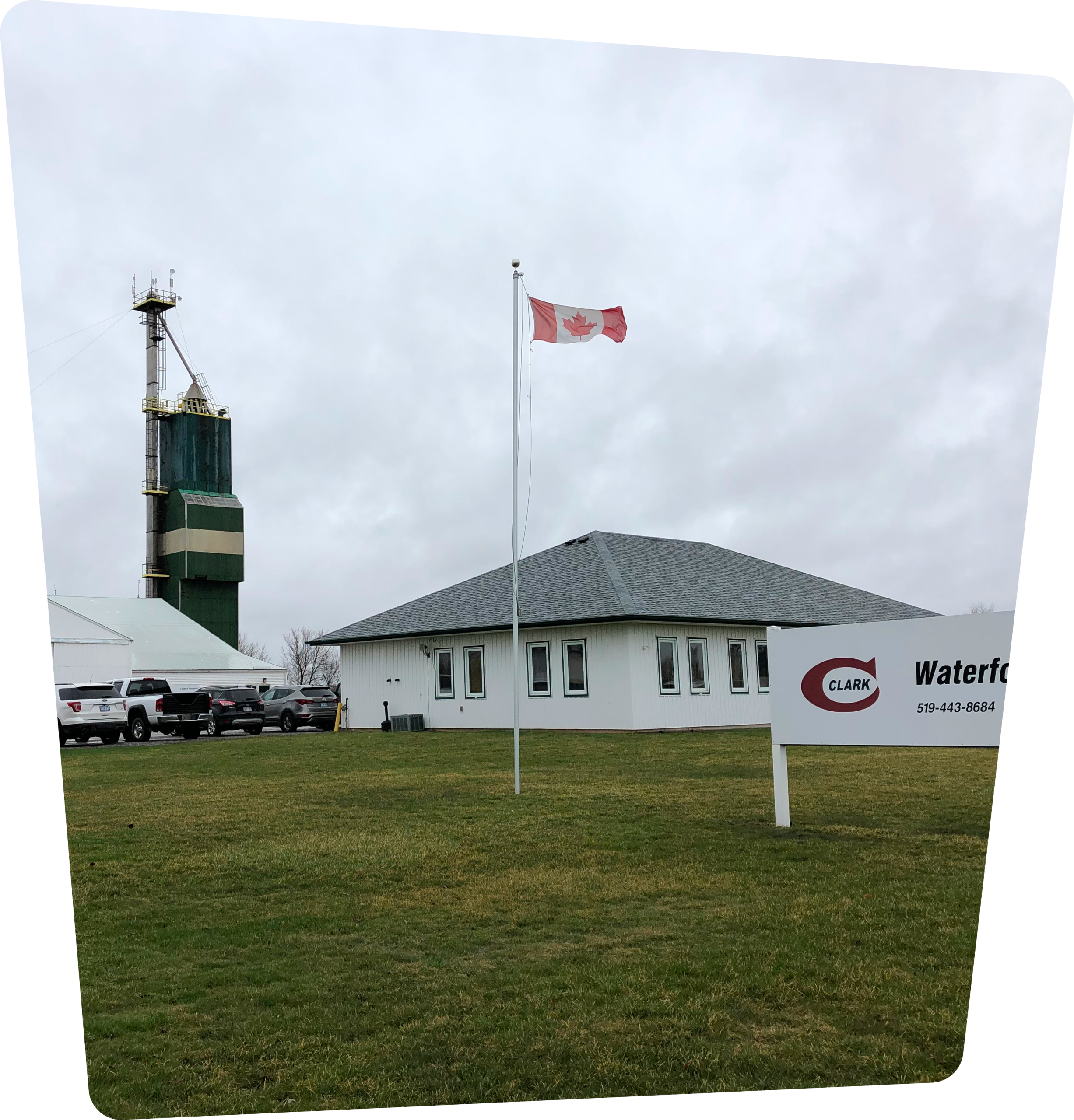 Office building with a Canadian flag and Clark Agri Service sign in front.